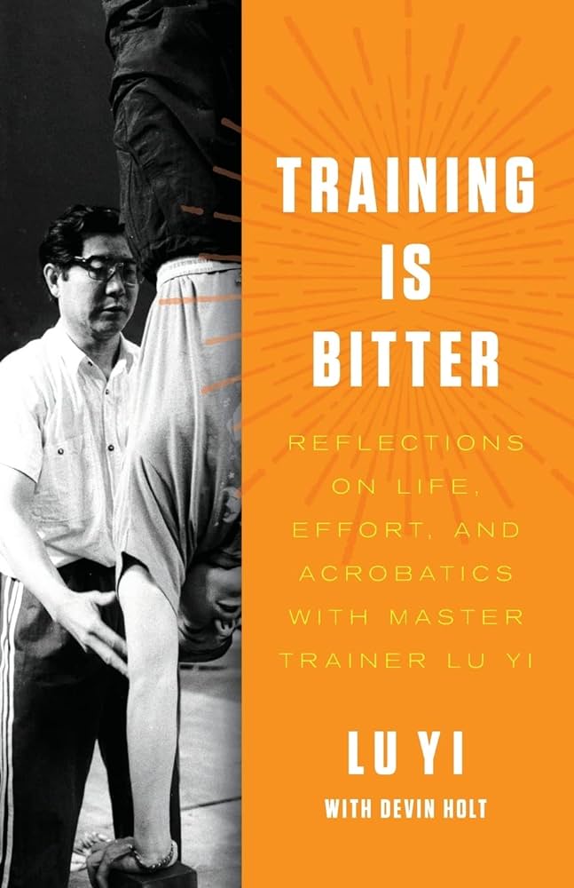 Cover of Training is Bitter, featuring black and orange cover with a photo of Lu Yi teaching a student doing a handstand on the left side.
